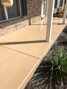 An beige concrete patio has a new epoxy coating.