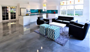 Entertainment space with grey Liquid Art metallic epoxy floor coating on the floor.