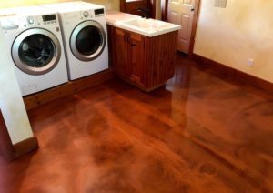 Metallic copper epoxy floor coating in a laundry room with white machines